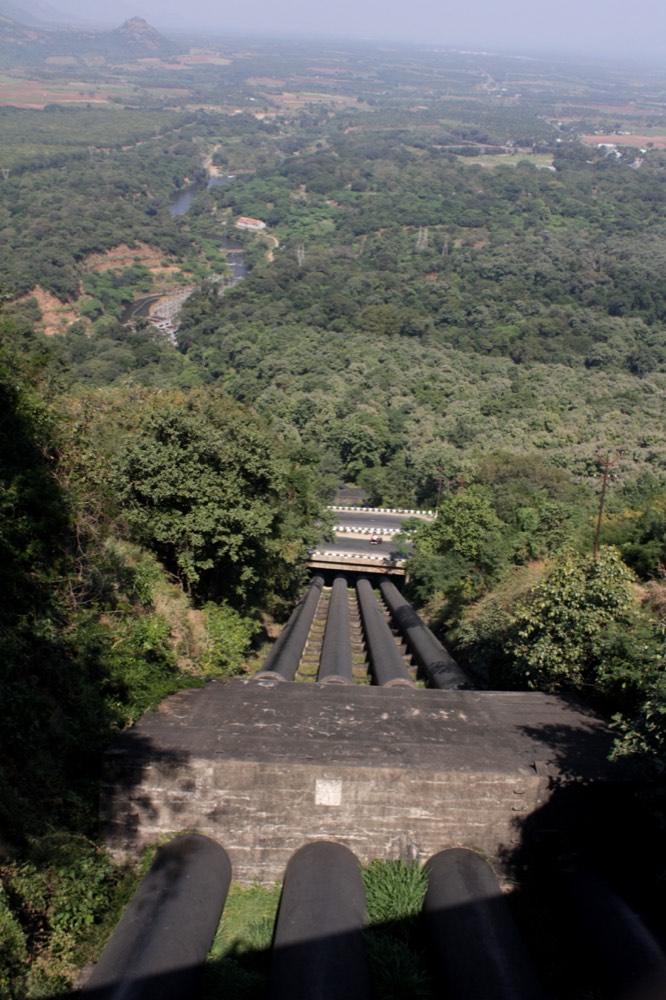 Penstock pipes and the canal carrying diverted water toward the lower dam and irrigation network